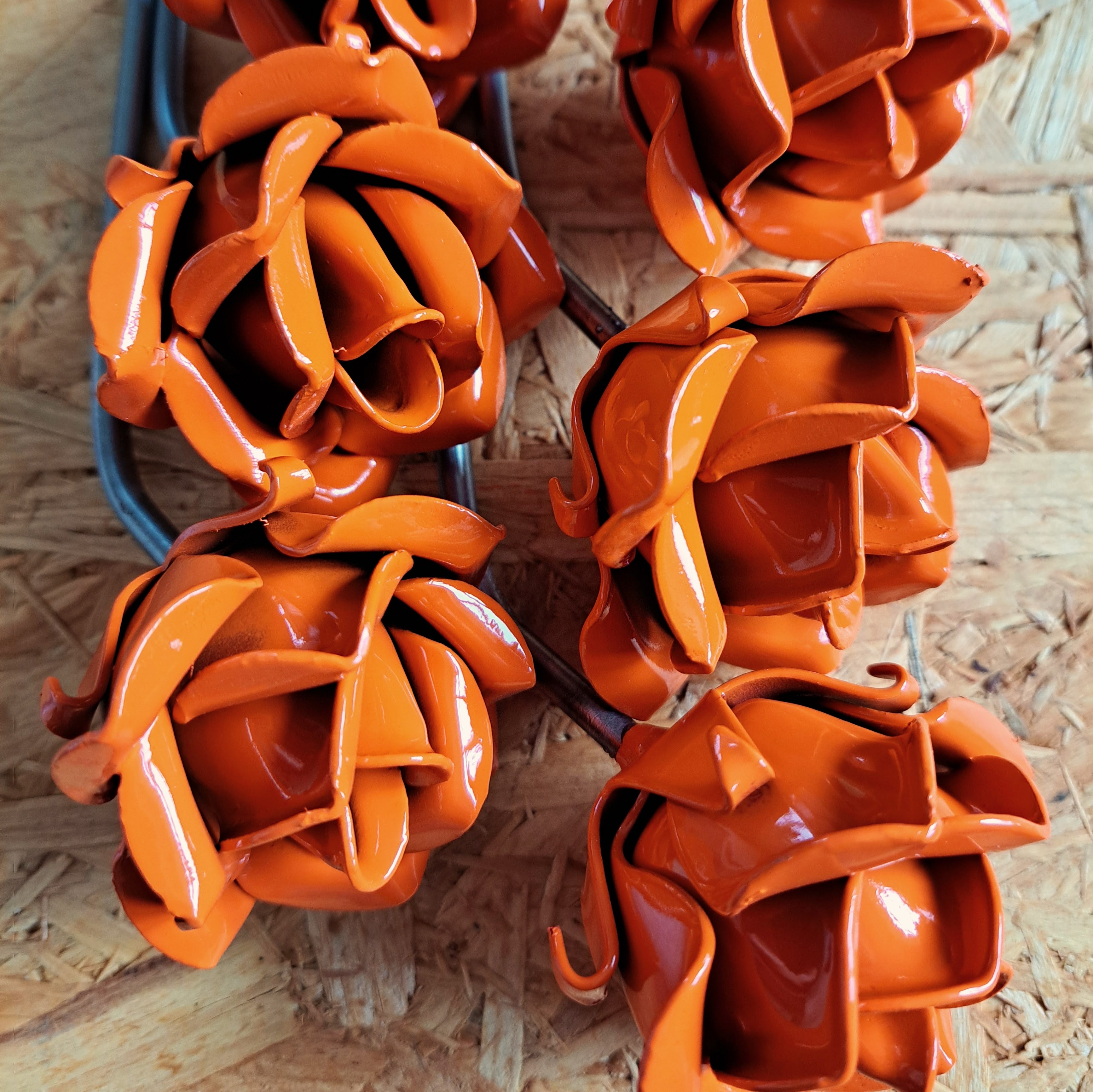 Close up of a group of orange painted steel roses