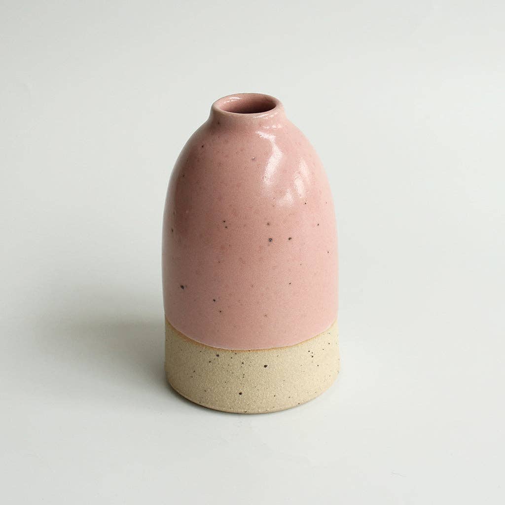 Medium pink ceramic vase on a white background