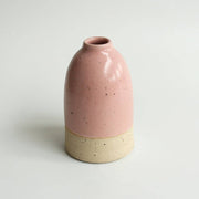 Medium pink ceramic vase on a white background