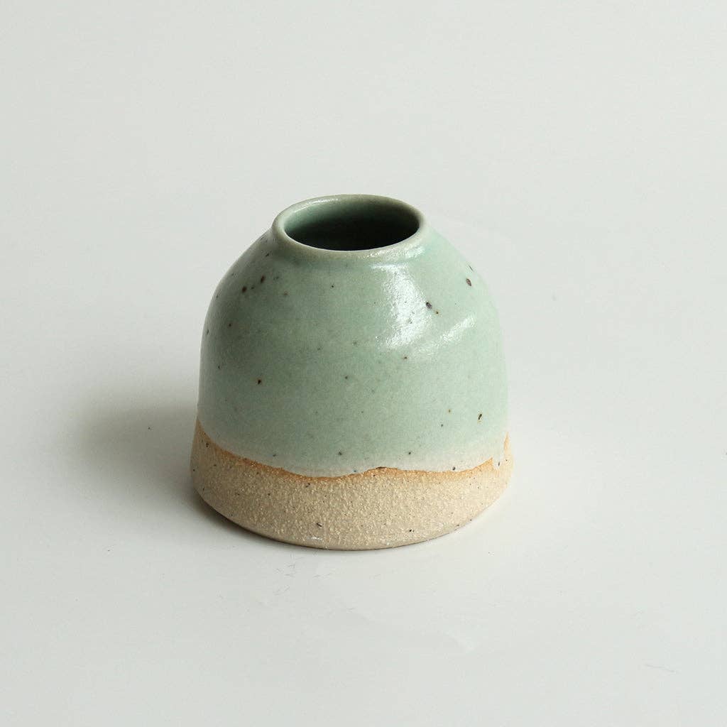 Mini mint green ceramic vase with two-tone glaze on a white background