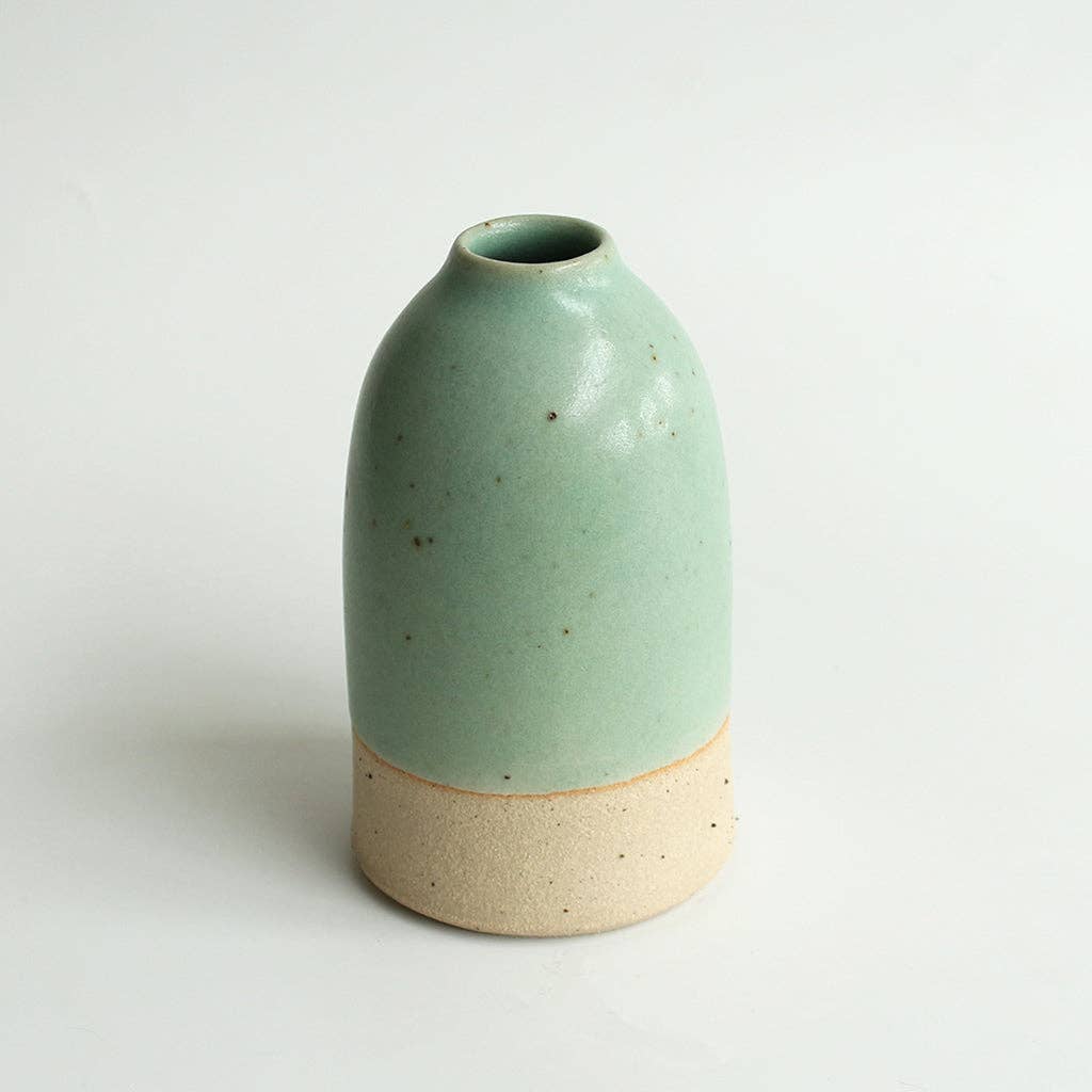 Medium mint green ceramic vase on a white background