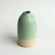Medium mint green ceramic vase on a white background