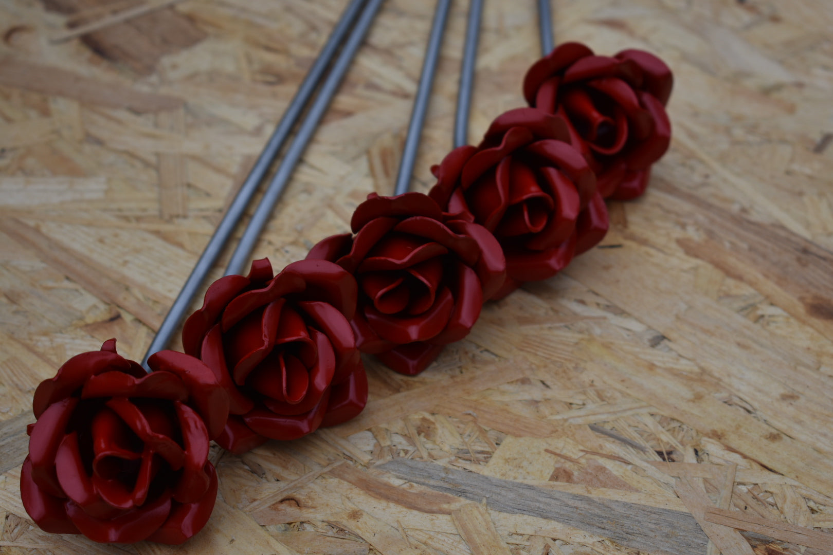 A group of red painted steel roses