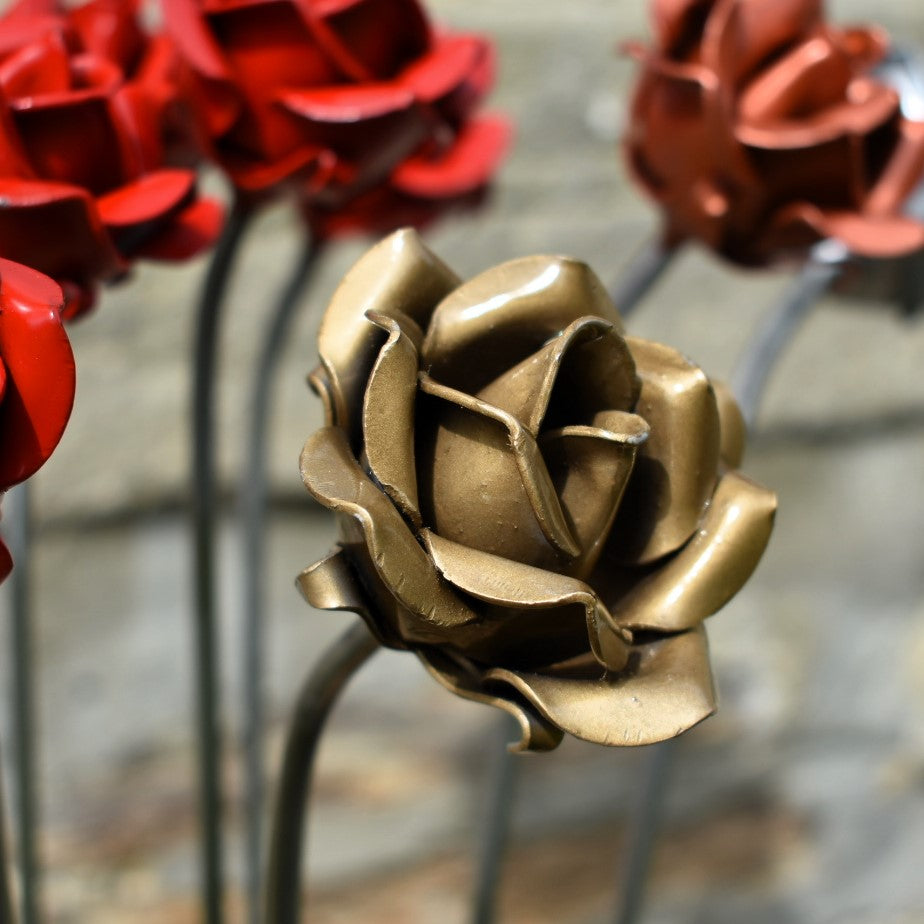 A gold painted steel rose in closeup