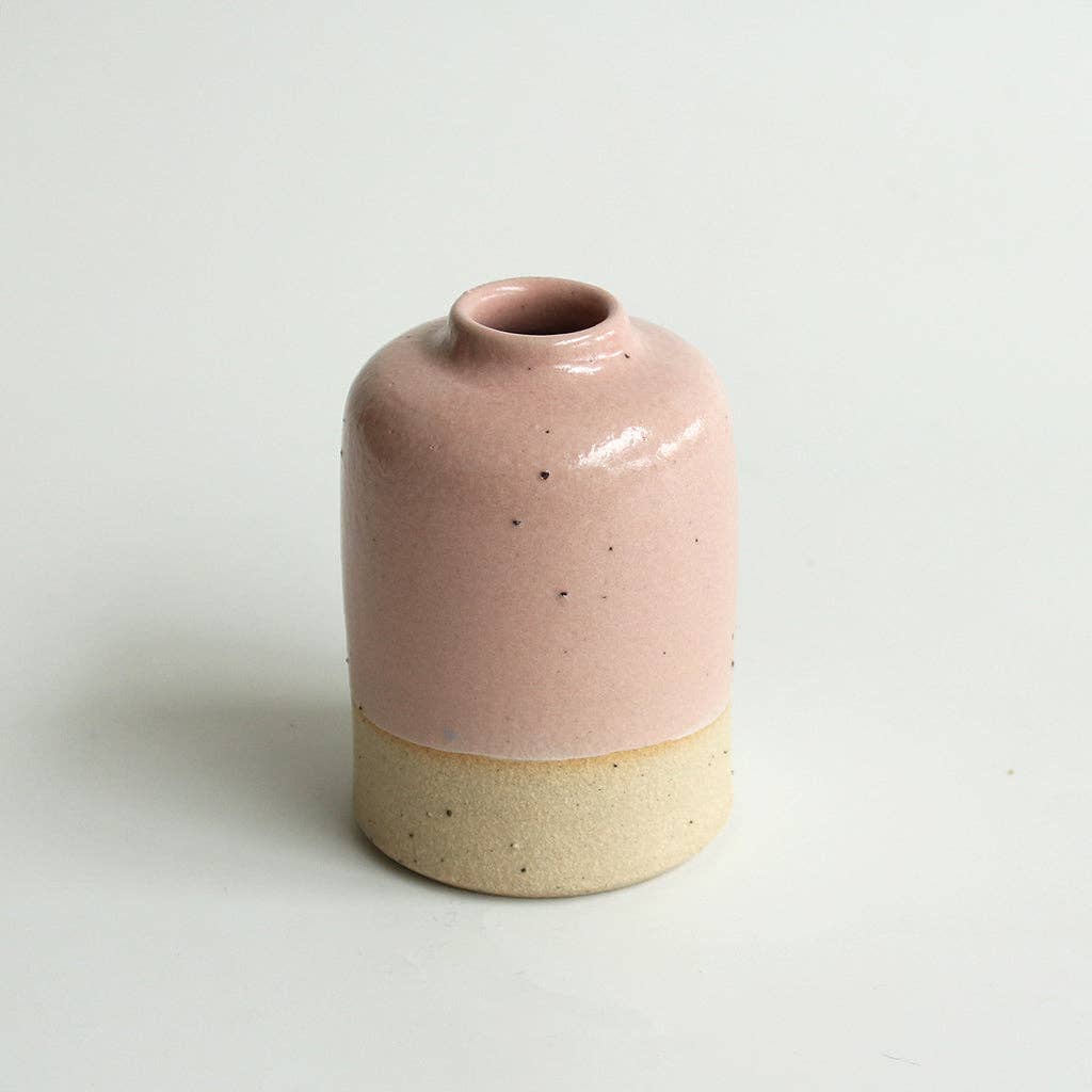 Small pink ceramic vase on a white background