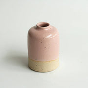 Small pink ceramic vase on a white background